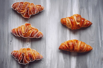 Five croissants on a concrete gray background