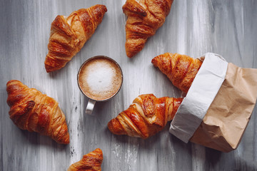 Croissants and a cup of coffee on a table