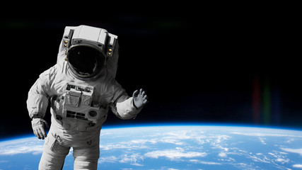 astronaut waving during a spacewalk in orbit of planet Earth © dottedyeti