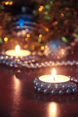 Christmas burning candles and tree decorations in New Years decor