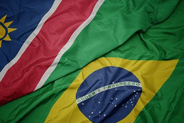 waving colorful flag of brazil and national flag of namibia.