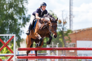 Horse rider woman on show jumping competition