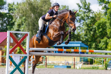 Horse rider woman on show jumping competition