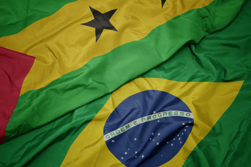 waving colorful flag of brazil and national flag of sao tome and principe .