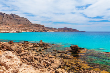 Sea skyview landscape photo near Agia Agathi beach and Feraklos castle on Rhodes island, Dodecanese, Greece. Panorama with sand beach and clear blue water. Famous tourist destination in South Europe