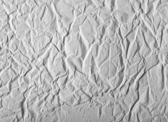 The texture of white gypsum with a microrelief of different shapes. White or light gray industrial background.