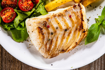 Fried cod loin with french fries and vegetables