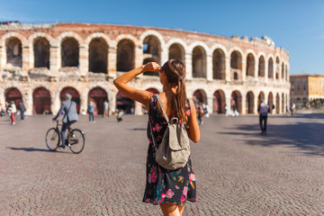 Toirust woman in Verona historical center on square near Arena Verona, Roman amphitheater. Traveler...