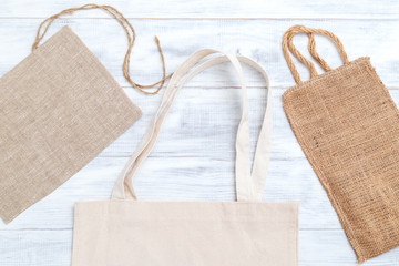 Organic bags on white wooden background. Zero waste