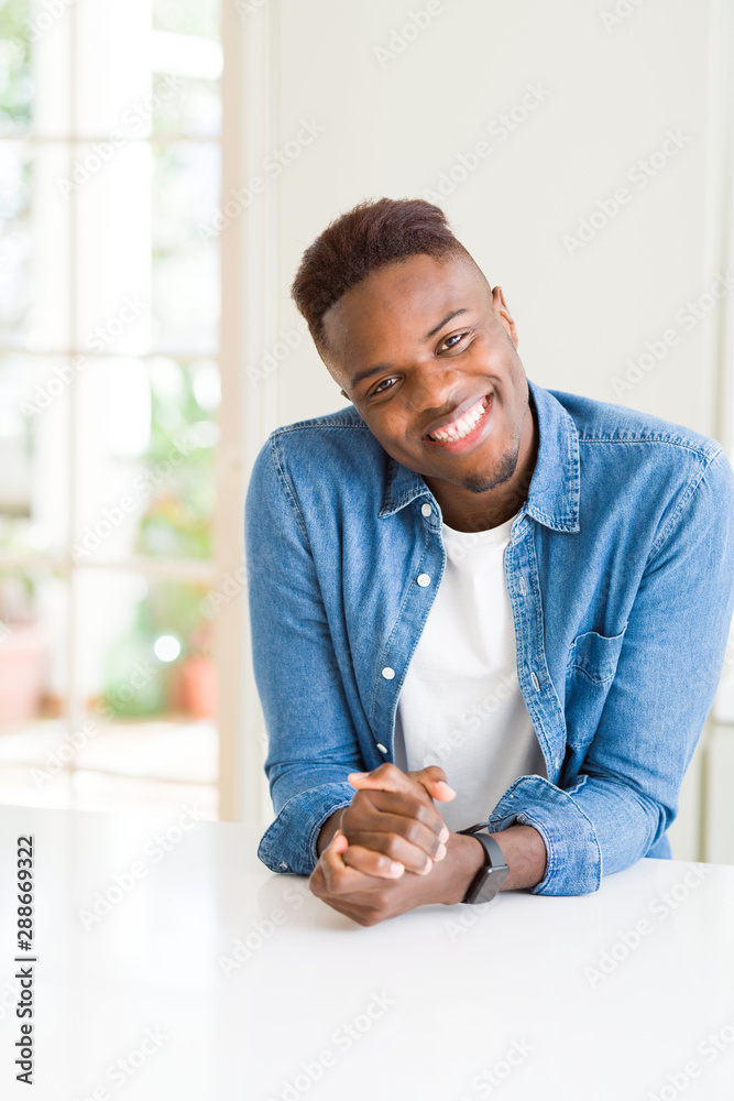 Sticker Handsome african young man smiling cheerful with a big smile on face