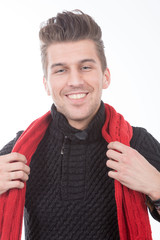 young smiling man in black sweater and a red scarf