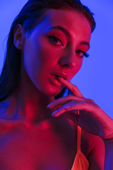 Image closeup of gorgeous caucasian woman wearing bodysuit underwear posing at camera