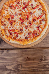 Pizza Restaurant Menu - Delicious Spicy Pizza with Sausages and Chili Pepper. Pizza on Rustic Wooden Table with Ingredients