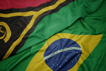waving colorful flag of brazil and national flag of Vanuatu .