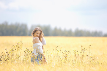 autumn field girl health / beautiful young model, landscape in a summer field, cute happy model