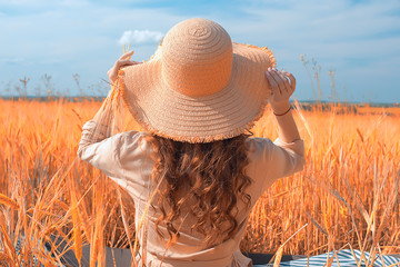 straw hat happiness view from the back / girl summer view from the back, young beautiful concept of happiness