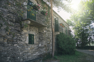 Obraz premium Street of old mediterranean town with stone houses and flowers. Galicia Spain.