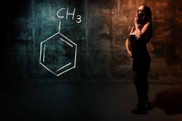 Sexy girl or secretary or female student presenting handdrawn chemical formula of toluene