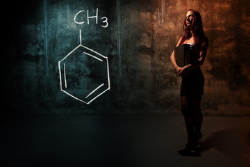 Obraz na płótnie Canvas Sexy girl or secretary or female student presenting handdrawn chemical formula of toluene