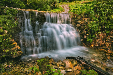 Waterfall in the forest, summertime outdoor backgriund