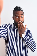 African american man with braids make selfie by camera over isolated white background cover mouth with hand shocked with shame for mistake, expression of fear, scared in silence, secret concept