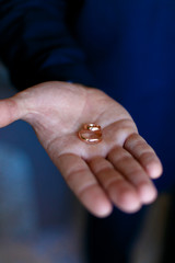 Groom holding wedding rings on the palm, wedding ring in groom hand..