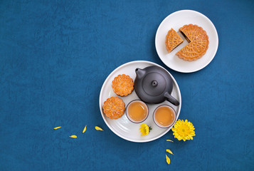 Minimal simplicity layout moon cakes on blue background for Mid-Autumn Festival, creative food design concept, top view, flat lay, copy space.
