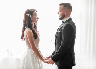 close up. happy bride and groom looking at each other