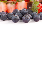 A bowl set of beautiful and delicious strawberry and blueberry isolated on white background, close up, copy space, clipping path, cut out.