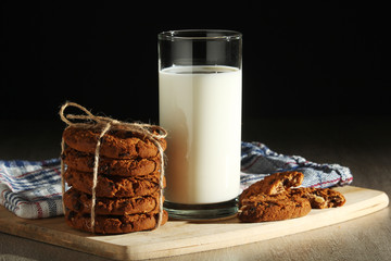 A glass with milk and chocolate cookies