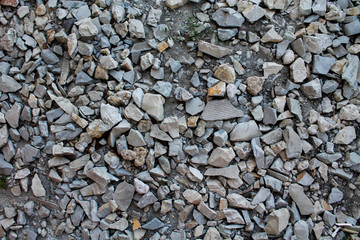Abstract background with gray rocks. Sharp stones on the ground. Textured rocky backdrop with copy space for text