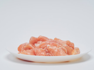Fresh chicken tenderloin in white plate