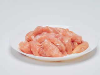 Fresh chicken tenderloin in white plate