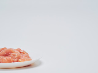 Fresh chicken tenderloin in white plate