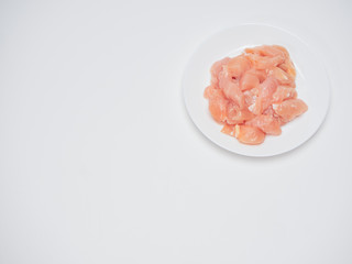 Fresh chicken tenderloin in white plate
