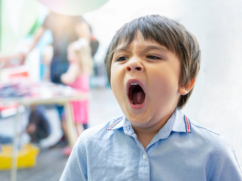 Kid yawning, Sleepy boy get allergy while playing at party, Tired child get a cold from allergy, Children has reflection or hay fever from dust mite,Allergies and asthma issues in kids
