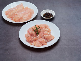 Fresh chicken tenderloin on stone table top