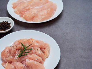 Fresh chicken tenderloin on stone table top