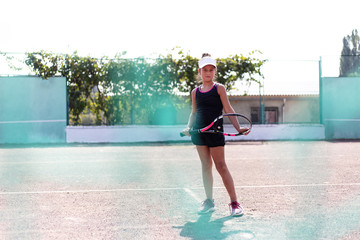 Through grid portrait of teenage tennis girl playing on court.
