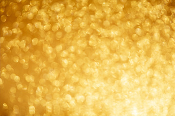 Gold glittering christmas lights. Blurred abstract background.