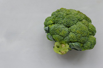 Broccoli on gray wooden background. Top view. Flat lay. Harvesting or healthy food concept.