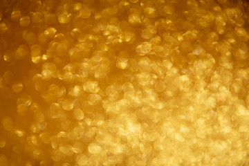 Gold glittering christmas lights. Blurred abstract background.