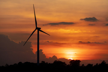 silhouette of wind turbine located on a ridge with wind blowing all the time. Making it able to effectively produce renewable electricity, which is another clean energy.