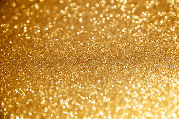Gold glittering christmas lights. Blurred abstract background.