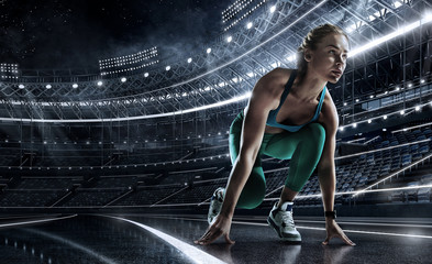 Sports background. Runner on the start line of the glowing stadium . Futuristic running track. Dramatic picture. - obrazy, fototapety, plakaty