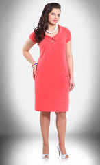 in full growth. female model in short red dress
