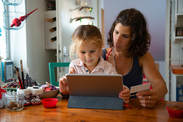 Mother paying with credit card from home