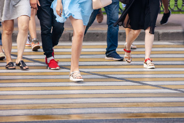 Fototapeta na wymiar feet of pedestrians at a pedestrian crossing