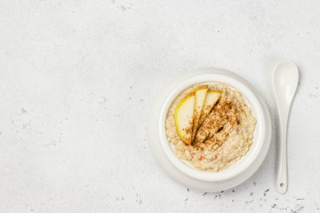 Spiced cinnamon apple pie porridge. Top view, space for text.