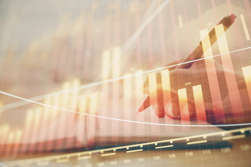 Forex graph on hand taking notes background. Concept of research. Multi exposure